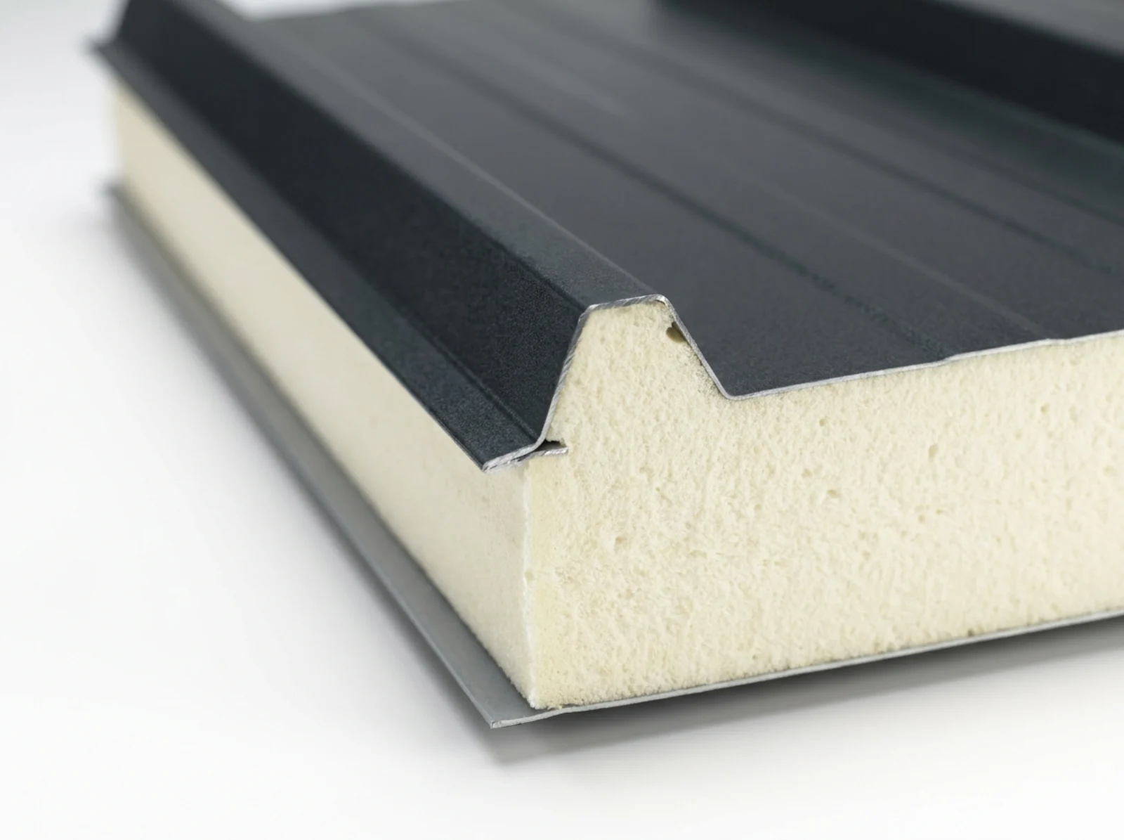 Cutaway of aluminium insulated roof panel showing rigid PU core bonded between aluminium skins